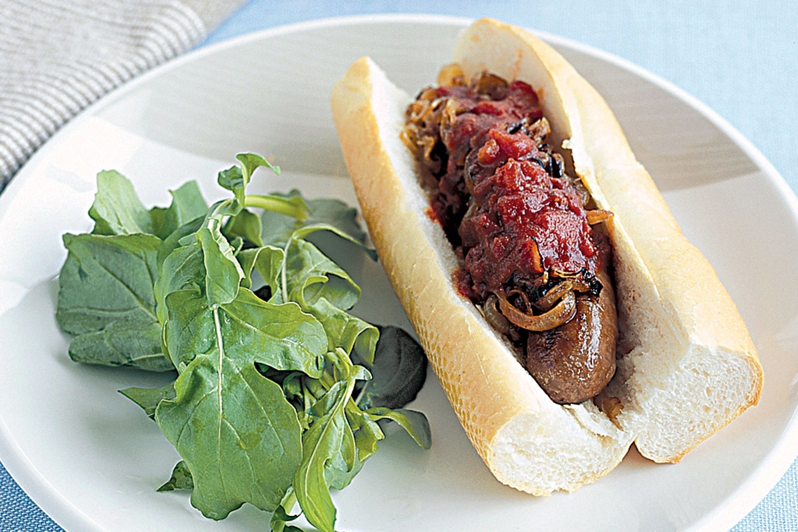 Kransky and onion on a roll